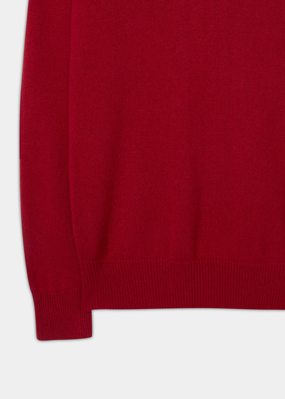 Close-up of a deep red Selkirk Pure Cashmere V-Neck Jumper In Ruby with a ribbed hem and cuff.