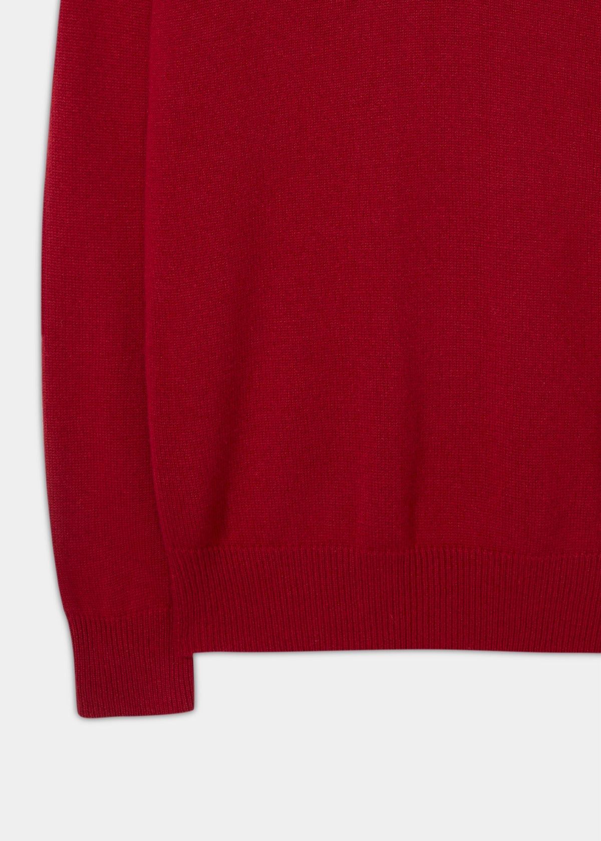Close-up of a deep red Selkirk Pure Cashmere V-Neck Jumper In Ruby with a ribbed hem and cuff.