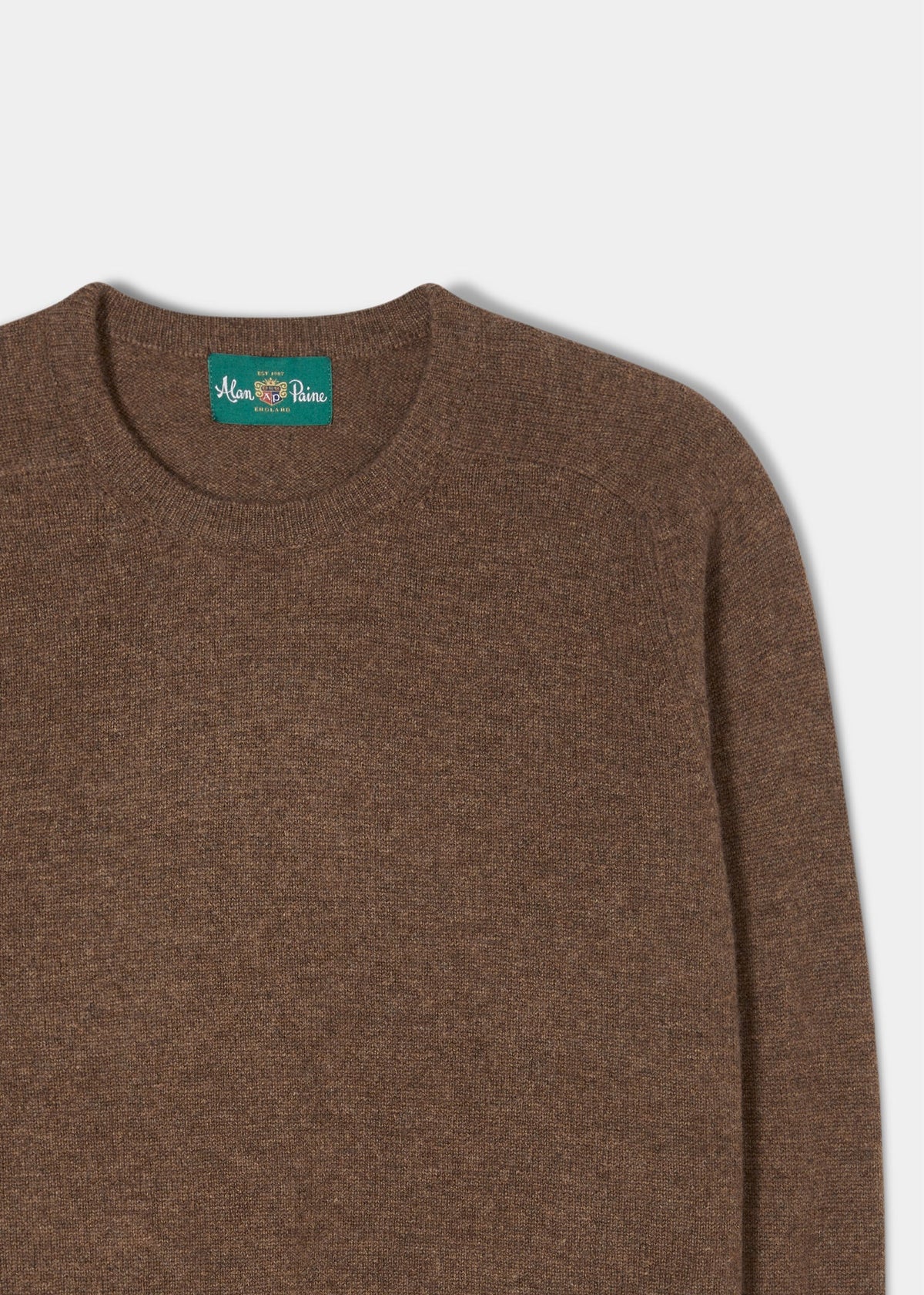 Lenzie Lambswool Crew Neck Jumper in Tobacco, regular fit, green Alan Paine label, shown on white background.