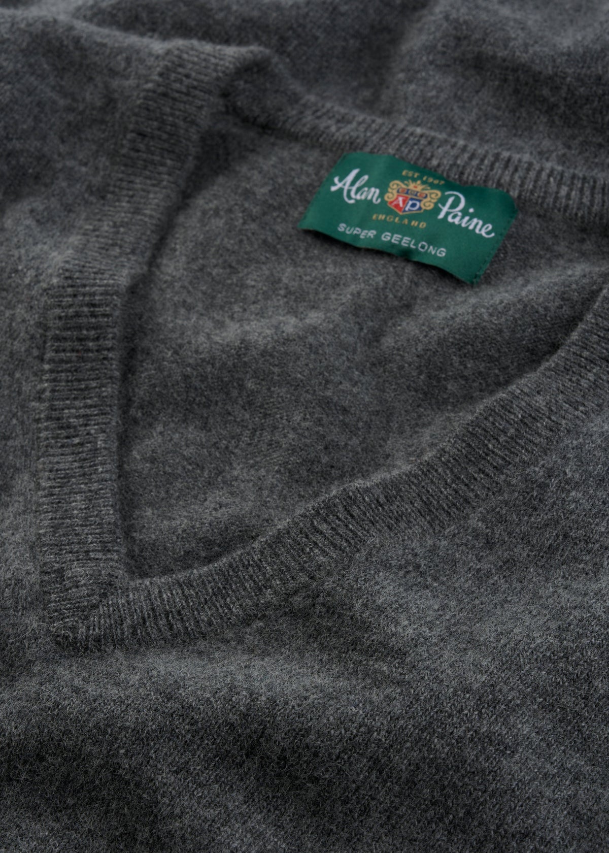 Close-up of gray Albury Geelong Wool V-Neck Jumper in Derby, regular fit, label visible inside neckline.