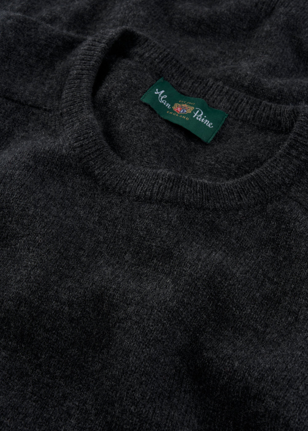 Close-up of Dorset Lambswool Crew Neck Jumper in Charcoal - Classic Fit, label visible at the neckline.