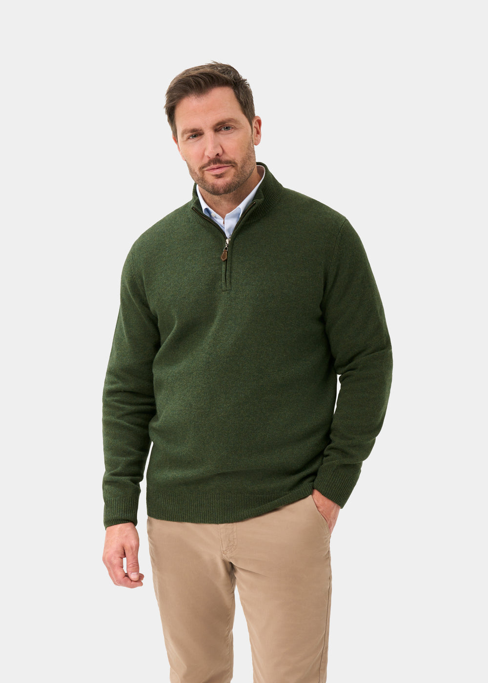Man wearing a Sutherland Lambswool Quarter Zip Jumper In Rosemary over a light blue collared shirt and tan trousers.