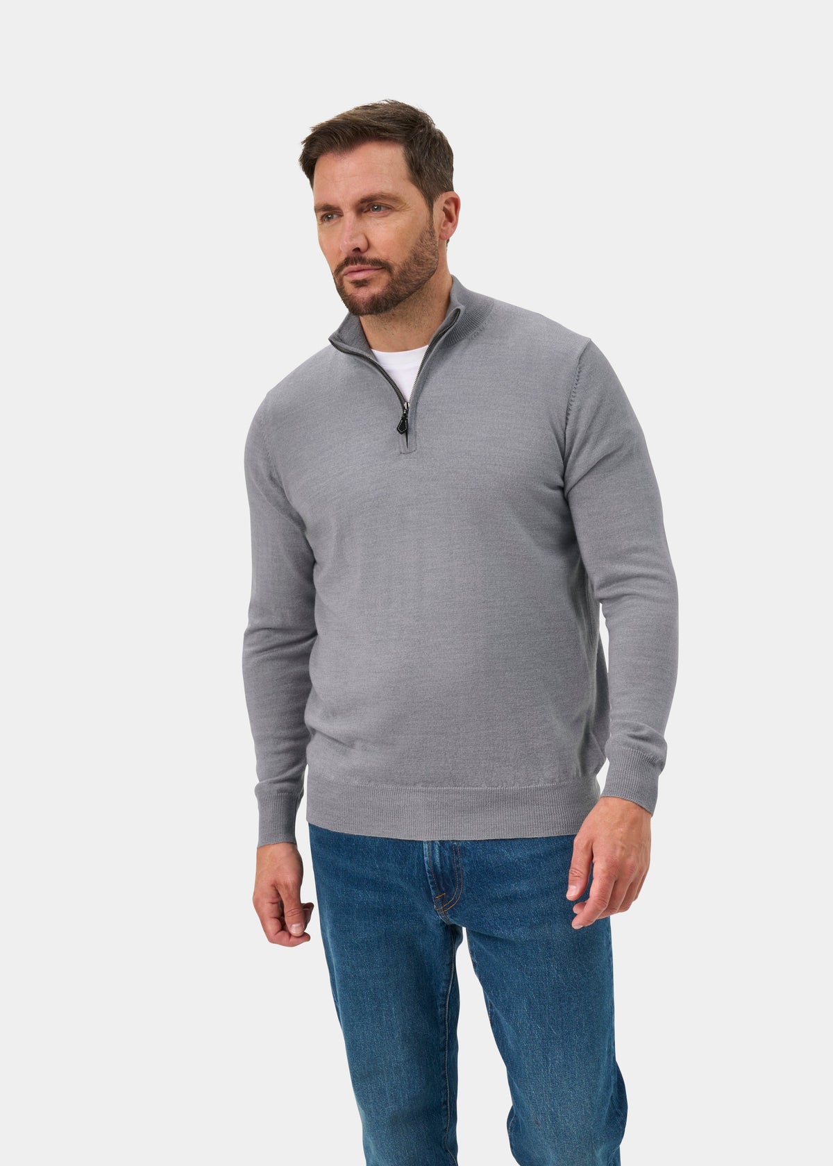 Man in Barton Merino Wool Quarter Zip Jumper, Light Grey Mix, Regular Fit, and blue jeans against a white backdrop.