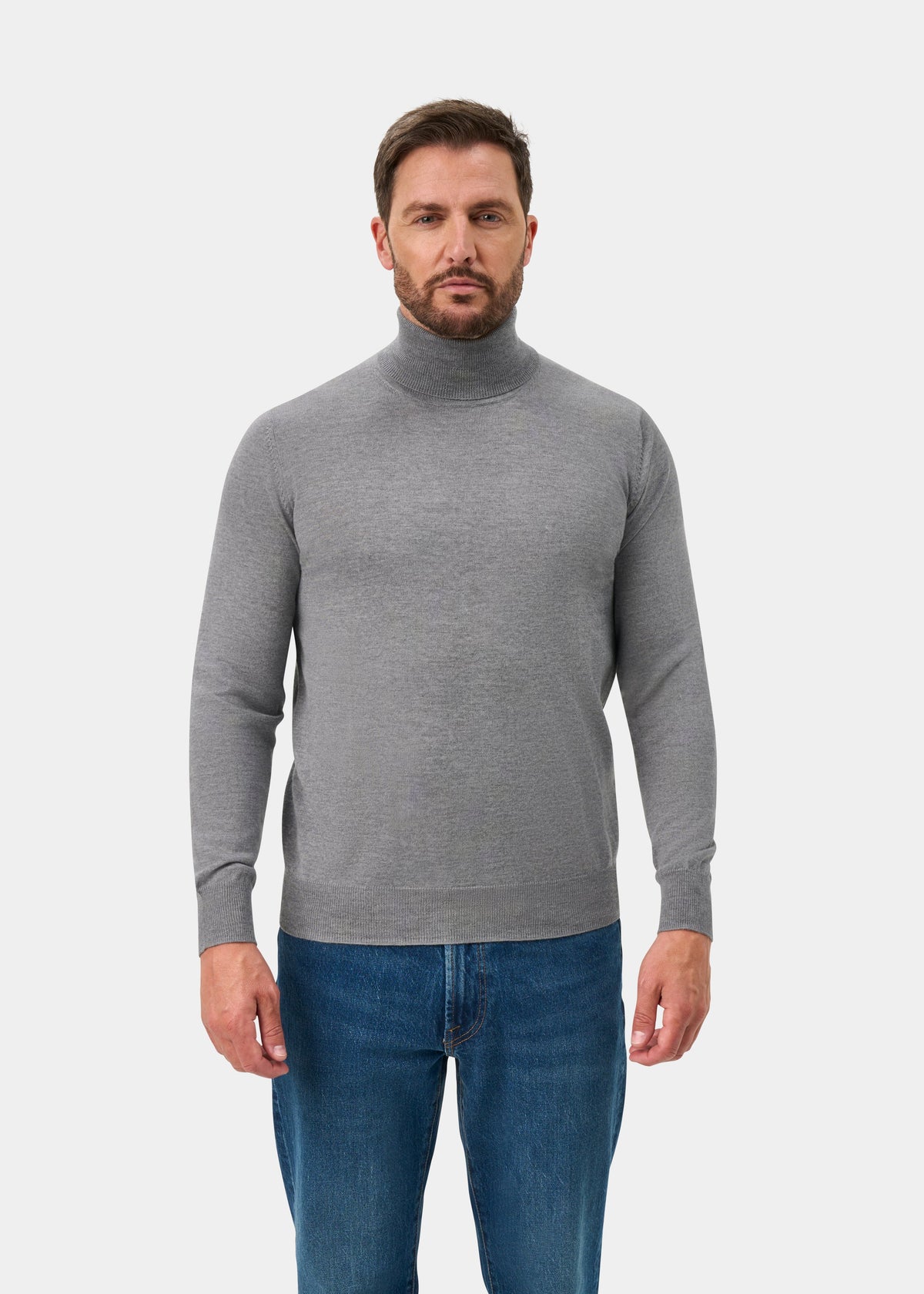 Man in Linton Merino Wool Roll Neck Jumper, Light Grey Mix, Regular Fit, with blue jeans on white background.
