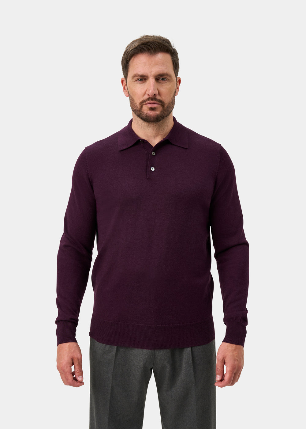 Man wearing Hindhead Men’s Merino Wool Polo Shirt in Black Grape, standing against a plain light background.