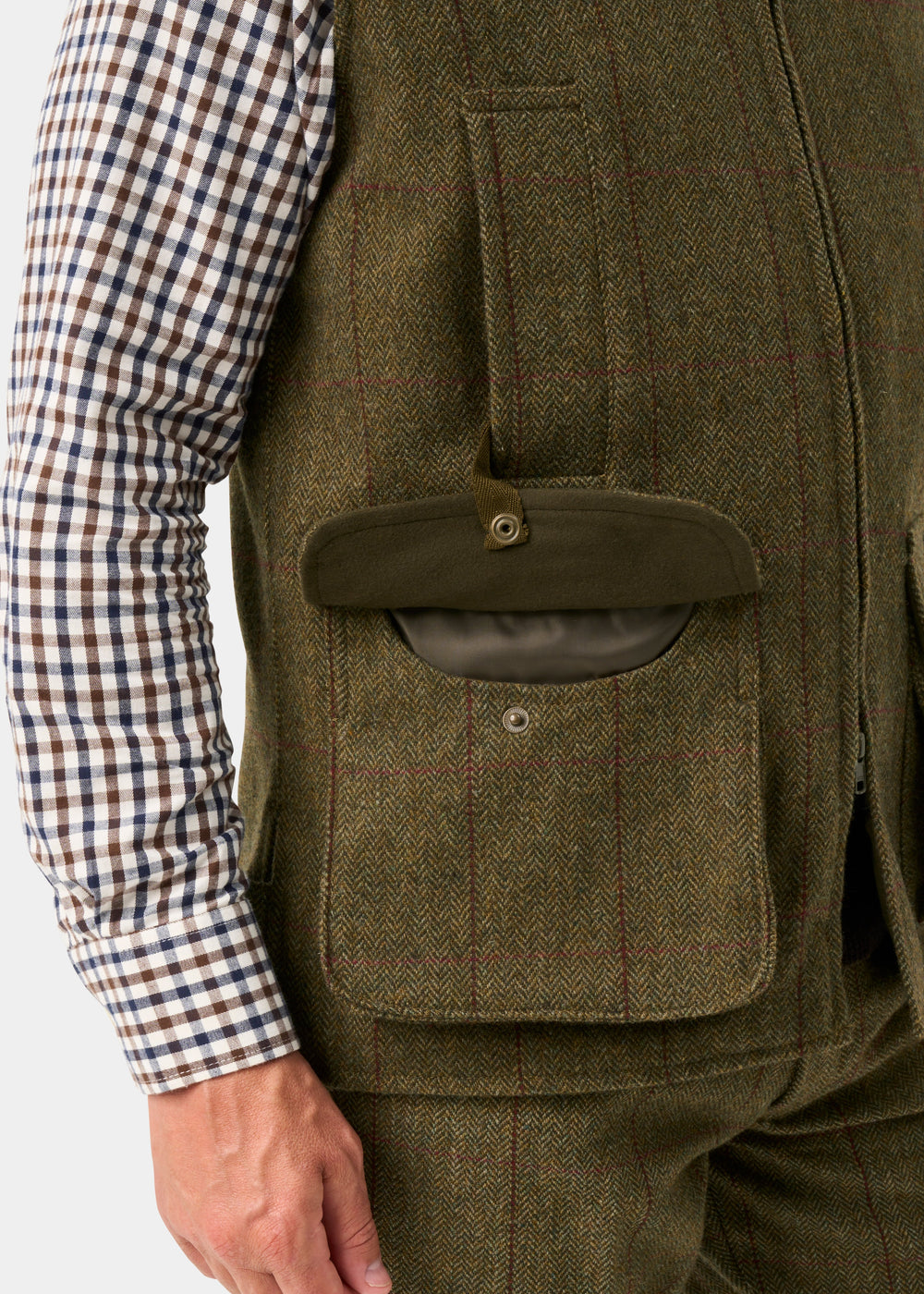 Rutland Men’s Tweed Water Repellent Waistcoat In Oakley, an olive green tweed waistcoat with large bellows pockets.