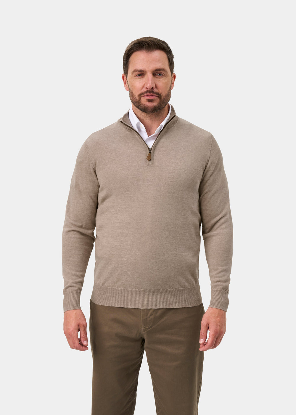 Man wearing Barton Merino Wool Quarter Zip Jumper in Cobble, over white shirt and brown pants, on a white background.