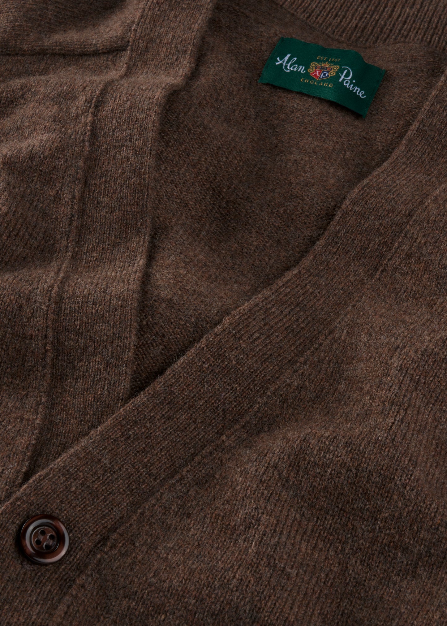 Close-up of a brown textured fabric with a brand label 