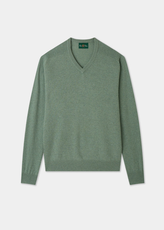 Green sweater on a light gray background