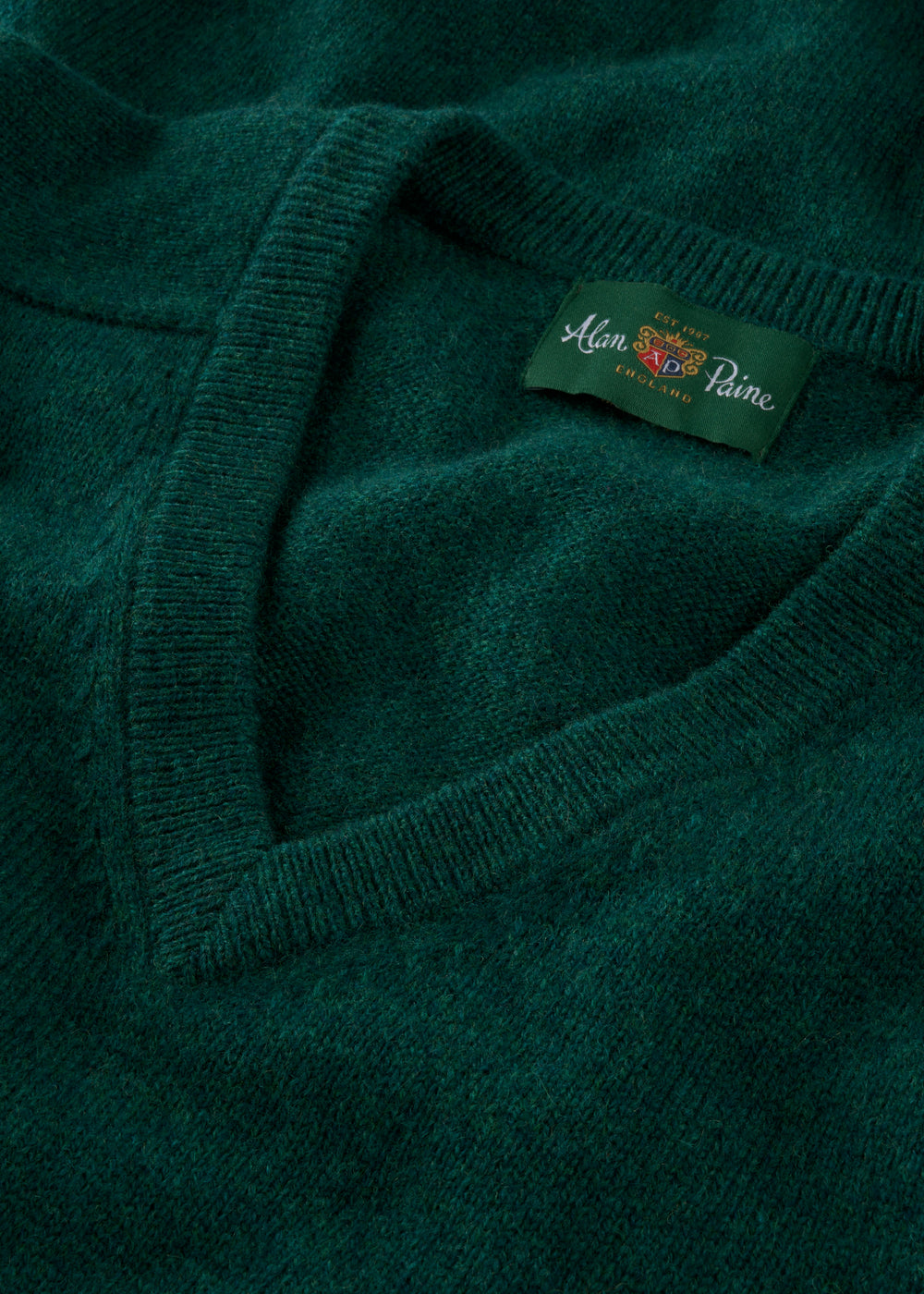 Close-up of a green sweater with brand label 