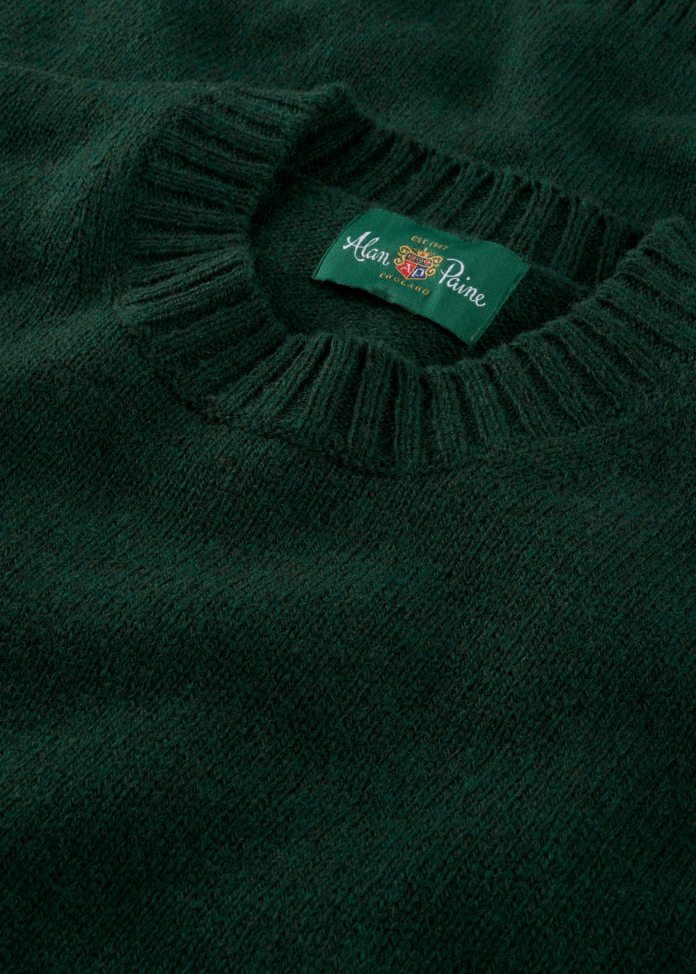 Close-up of the Kinnadie Supersoft Shetland Wool Crew Neck Jumper in Cossack, regular fit, with Alan Paine label.