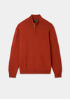 Orange jumper with a zipper on a light gray background